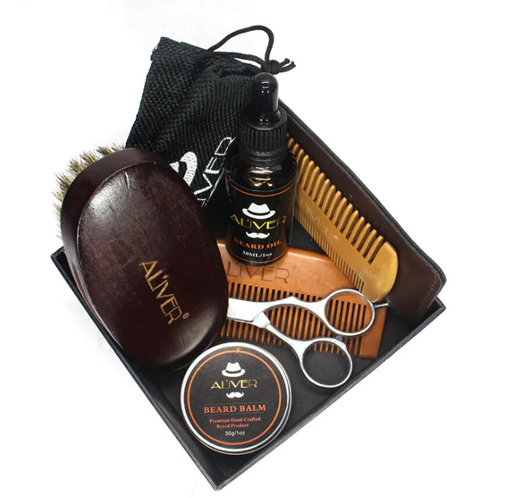 Beard grooming kit with brush, oil, balm, comb, and scissors in a black box.
